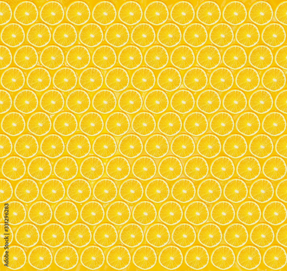 Texture of sliced orange slices on yellow background. Healthy lifestyle