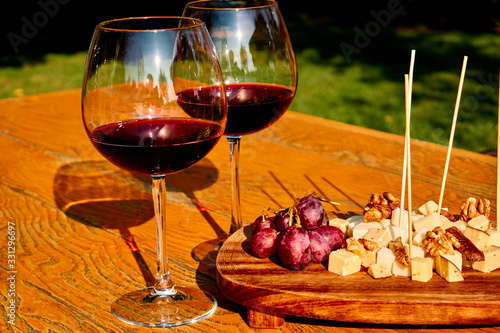 Glasses Of Fine Red Wine With Grape and Cheese