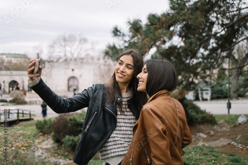 Fashion girls making selfie in the park