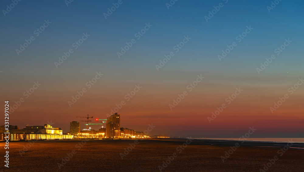 Panorama of Oostende (Ostend) city at sunset with its waterfront promenade, beach and North Sea, Belgium.