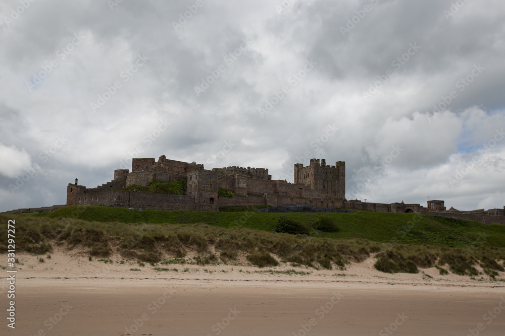 Bamburgh castle in Northumberland England as seen from the sand dunes on the beach