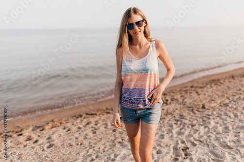 Young girl posing standing on the beach on a Sunny day