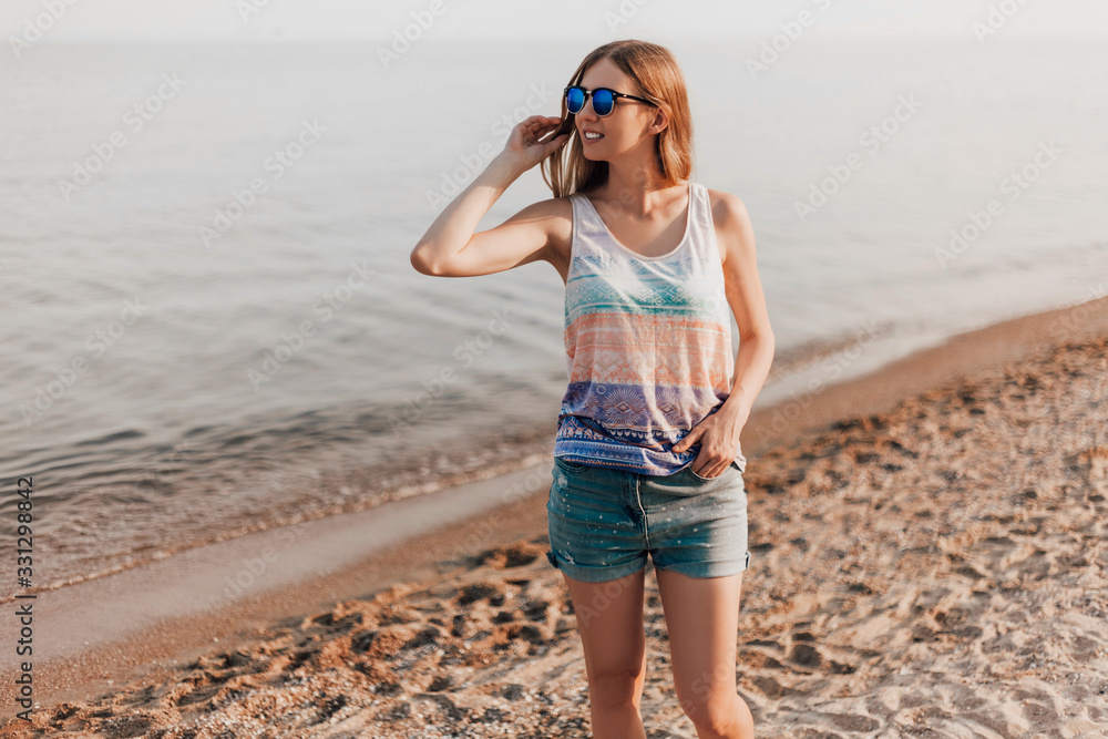 Young girl posing standing on the beach on a Sunny day Young girl posing standing on the beach on a Sunny day