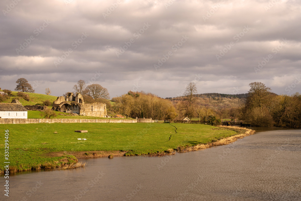 River bank with abbey ruins.
