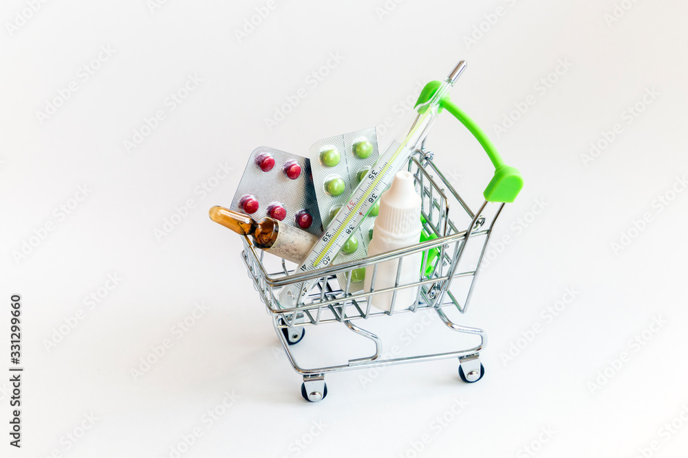 shopping trolley full of medical treatments: pills, thermometer, drops