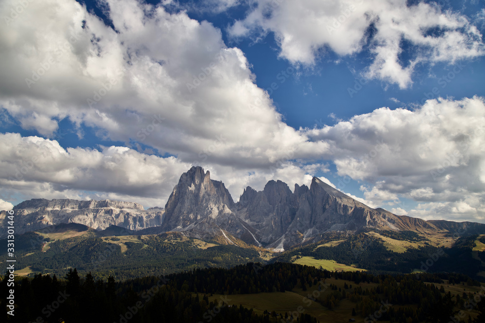 Alp di Siusi, one of the beautiful mountain in Dolomites during autumn under cloudy and blue sky.