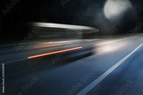 Car goes on the high speed on night highway