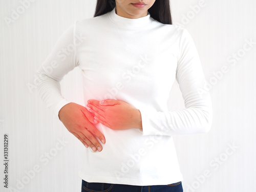 hepatitis and cirrhosis, including bile duct cancer in woman and she touching in the upper right portion of abdomen and above stomach symptoms of pain and suffering use for health care concept. photo