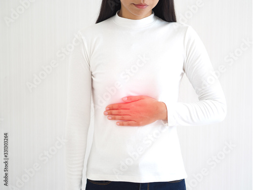 esophageal cancer in woman, She touching her chest and symptoms of pain and suffering in the the lower esophageal sphincter between the esophagus and stomach use for health care concept. photo
