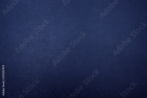 Dark blue metallic textured background with a gradient.