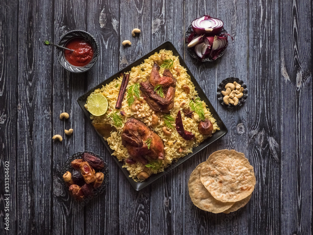 Festive dish with baked chicken and rice. Mandi Kabsa, Yemenis style Festive dish with baked chicken and rice. Mandi Kabsa, Yemenis style