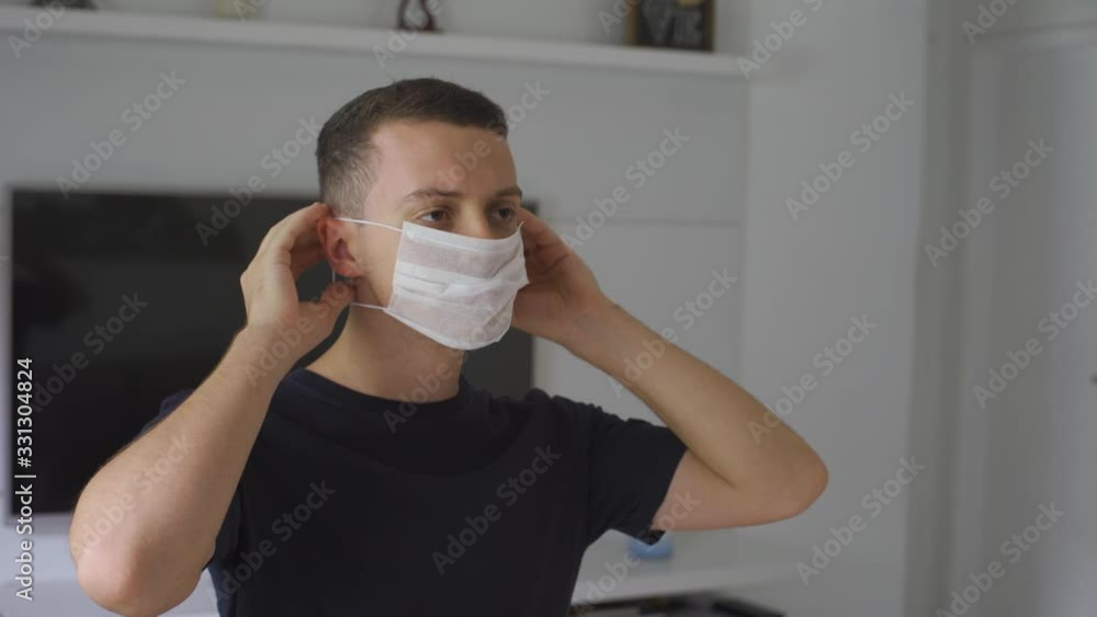 young man wearing white mask to prevent coronavirus young man wearing white mask to prevent coronavirus