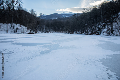 frozen lake with forest © Daniel