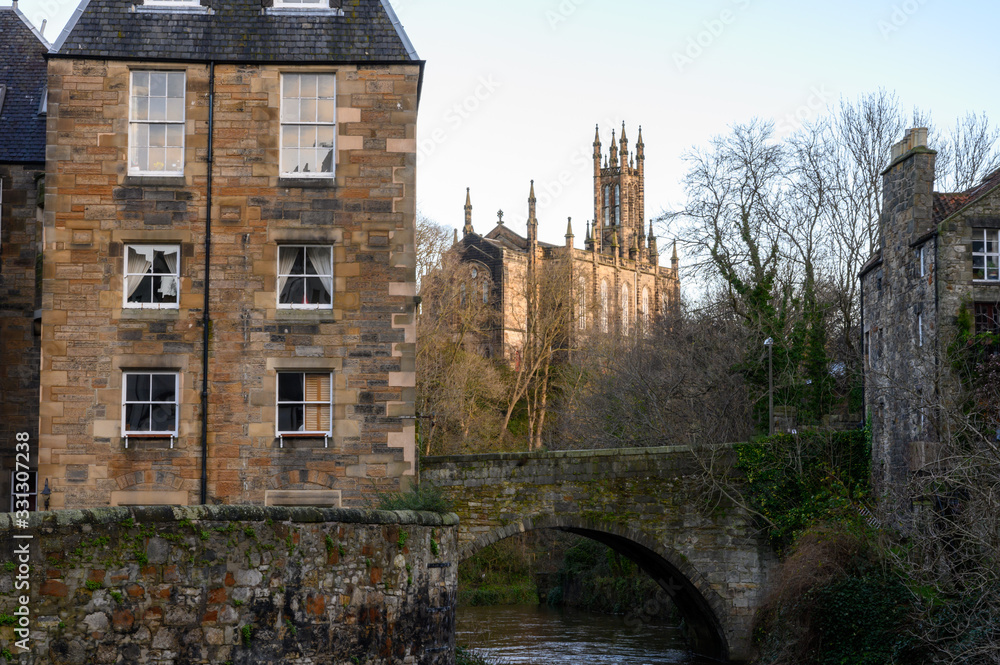 View on old houses in Dean village in New Town part of Edinburgh city, capital of Scotland, in sunny winter day