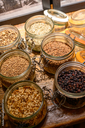 Tastes of gin, botanicals ingredients for gin distillery process, dried orange peels, juniper berries, heather, angelica, coriander, clove, cassia, liquorice