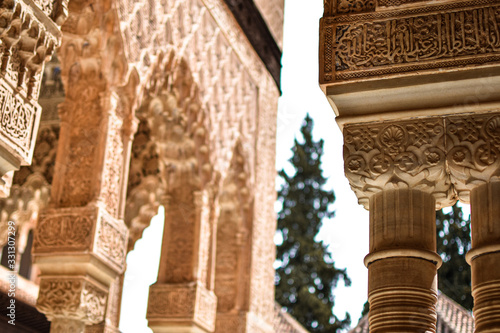 Archs and columns with Arabic patterns in La Alhambra, Granada, Spain