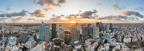 Aerial panoramic drone shot of La Defense skycraper in Paris business district with  clouds during sunset photo