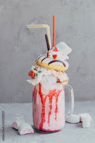 big and very sweet overshake with various sweets. photo