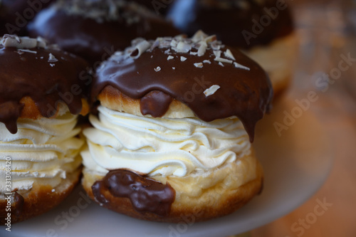 Scottish cream choux buns with chocolate close up