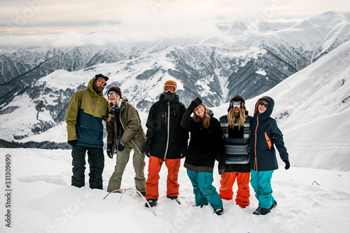 Group of travellers posing on mountain top photo