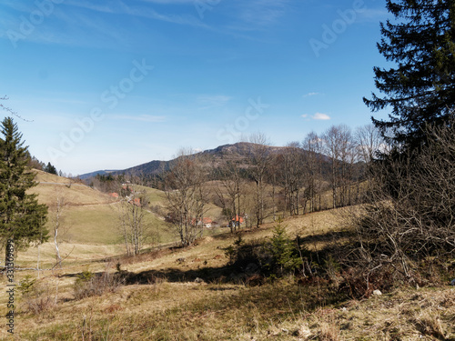 Around the lake of Nonnenmattweiher, beautiful hiking place with view on village Haldenhof and Belchen massif in Black-Forest, south Germany photo