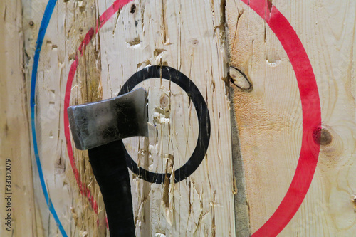 An axe stuck in the middle of the bullseye during an axe-throwing competition