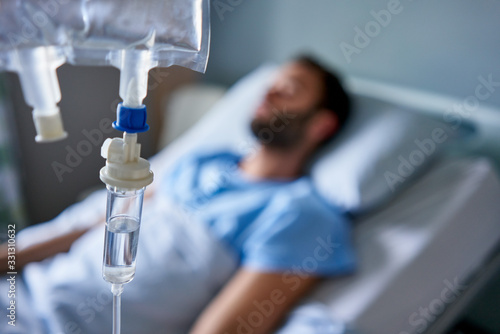 Murais de parede Sick man attached to an intravenous drip in a hospital
