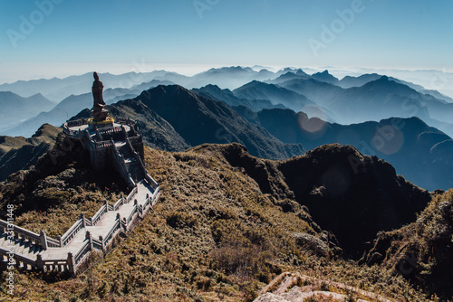 Fansipan mountain in Sapa, Vietnam. Statue of the Guan-Yin Buddha and Pavilion on Fansipan mountain peak the highest mountain in Indochina Backdrop Beautiful view blue sky in early morning.