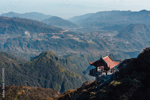 Fansipan mountain in Sapa, Vietnam. Statue of the Guan-Yin Buddha and Pavilion on Fansipan mountain peak the highest mountain in Indochina Backdrop Beautiful view blue sky in early morning.