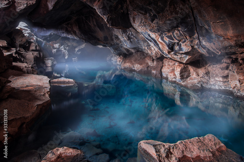 cave with blue geothermal pool