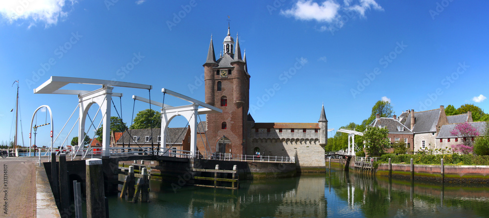 Panoramic view of Zuidhavenpoort city gate and drawbridge over a harbor channel in Zierikzee city, Netherlands