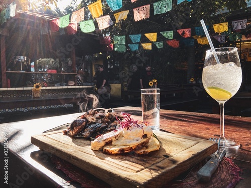 Ensenada. Baja California. Mexico. Steak on the wooden board. Margarita cocktail. La Houguera restaurant. Food in Mexico.