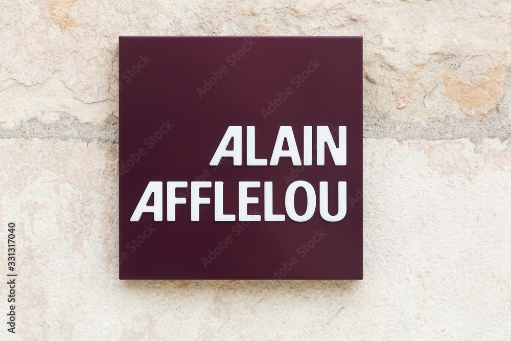 Villefranche, France - September 22, 2019: Alain Afflelou logo on a wall. Alain Afflelou is a French company, chain of opticians specialized in the distribution of frames and optical glasses Villefranche, France - September 22, 2019: Alain Afflelou logo on a wall. Alain Afflelou is a French company, chain of opticians specialized in the distribution of frames and optical glasses