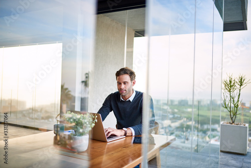 Businessman using a laptop while working from home