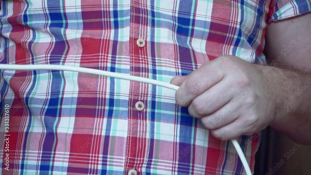 men's hands unravel electrical wires. men's hands unravel electrical wires.