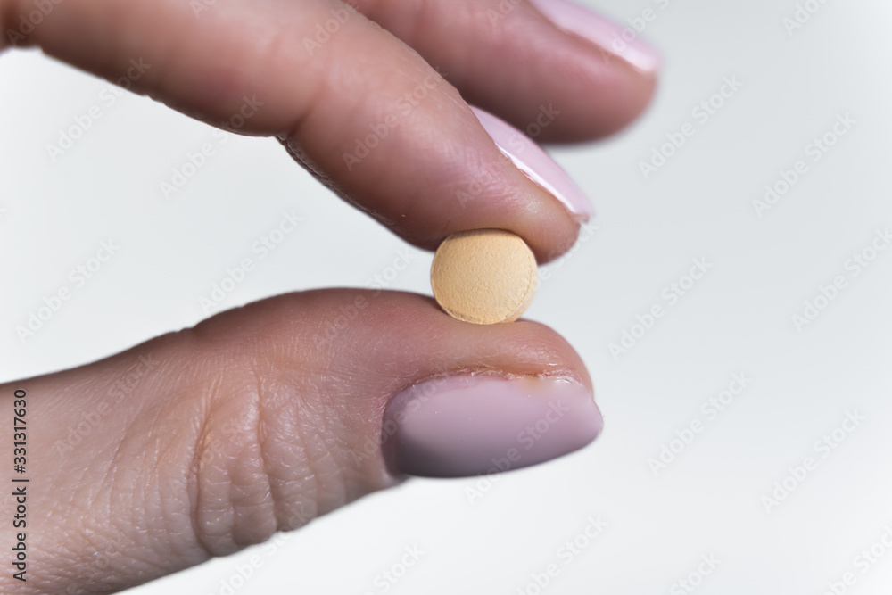Woman holds small antiviral pill in hand. Drug researched in laboratory speeds up coronavirus recovery in early trials of COVID-19. Active against virus SARS-CoV-2 and ebola disease curation Woman holds small antiviral pill in hand. Drug researched in laboratory speeds up coronavirus recovery in early trials of COVID-19. Active against virus SARS-CoV-2 and ebola disease curation