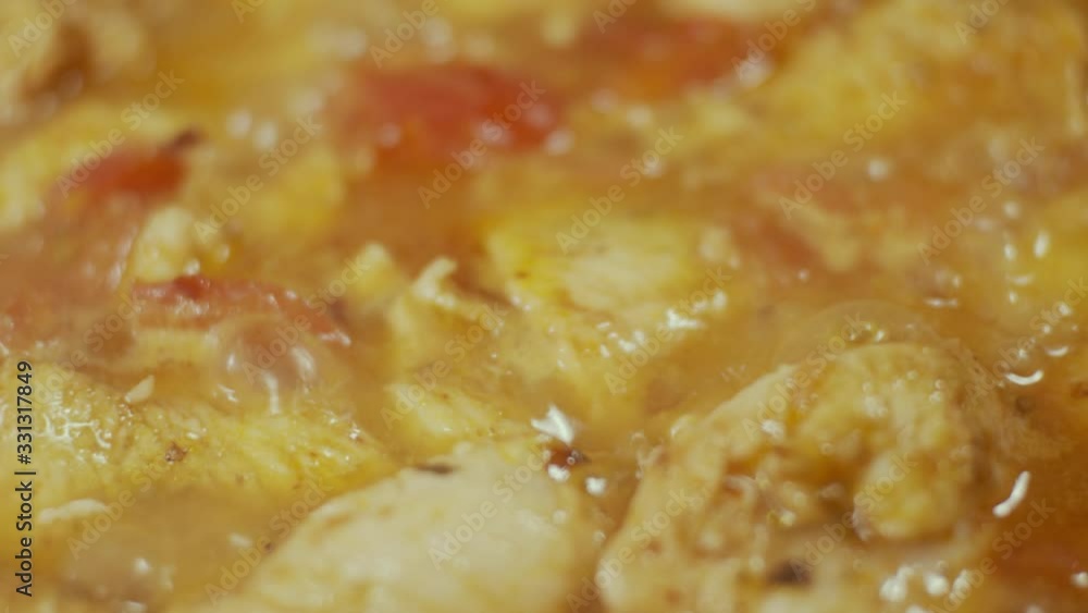 Chicken meat in frying pan, process of frying in oil, shallow depth of field, slow motion Chicken meat in frying pan, process of frying in oil, shallow depth of field, slow motion