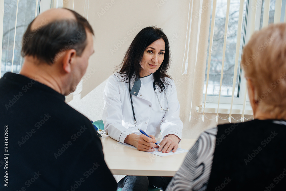 A couple of elderly people at a personal doctor's appointment at a medical center. Medicine and healthcare A couple of elderly people at a personal doctor's appointment at a medical center. Medicine and healthcare