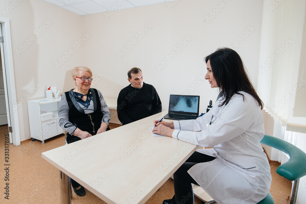 A couple of elderly people at a personal doctor's appointment at a medical center. Medicine and healthcare A couple of elderly people at a personal doctor's appointment at a medical center. Medicine and healthcare