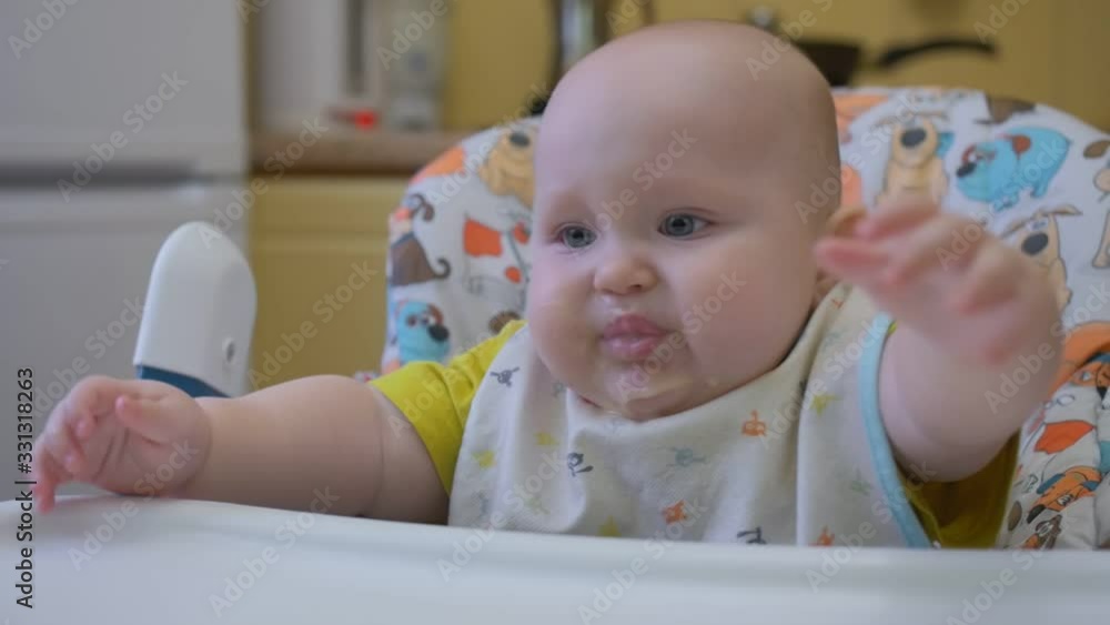 Mother feeding little baby with vegetable mash at home kitchen. Mother feeding little baby with vegetable mash at home kitchen.