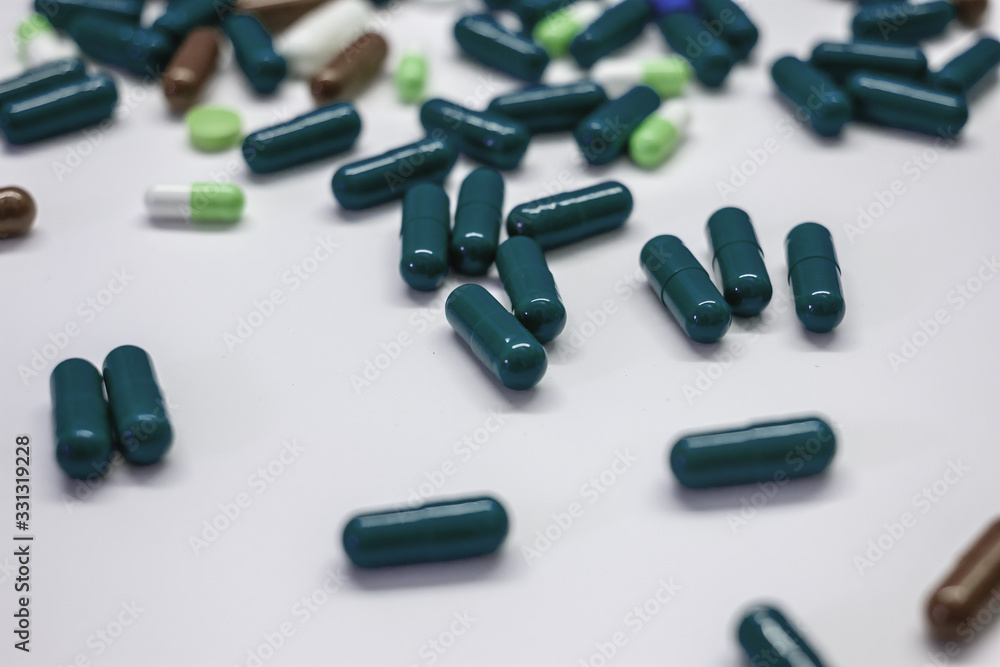 pills and capsules on white table surface pills and capsules on white table surface