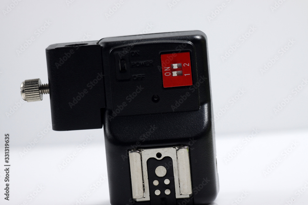 Close up shot of black camera flash trigger isolated on white background Close up shot of black camera flash trigger isolated on white background