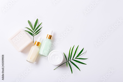 Herbal dermatology cosmetic products and cream on white background