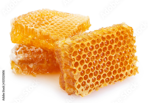 Honeycomb with honey on white background
