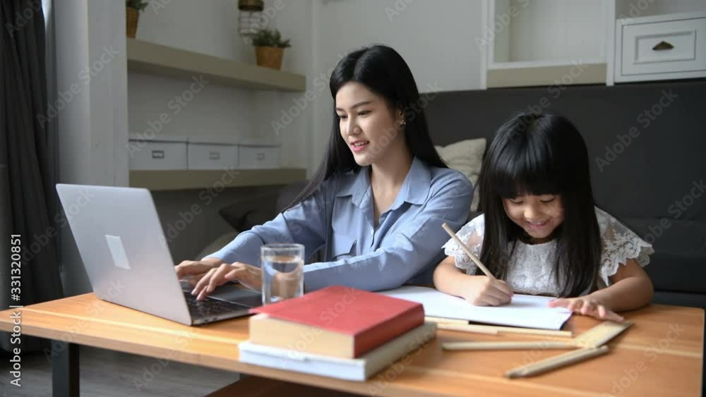 Family concept. Mother is working at home and looking after her daughter. 4k Resolution. Family concept. Mother is working at home and looking after her daughter. 4k Resolution.
