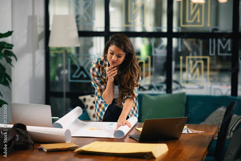 Beautiful young businesswoman working on project . Casual businesswoman in office. Beautiful young businesswoman working on project . Casual businesswoman in office.