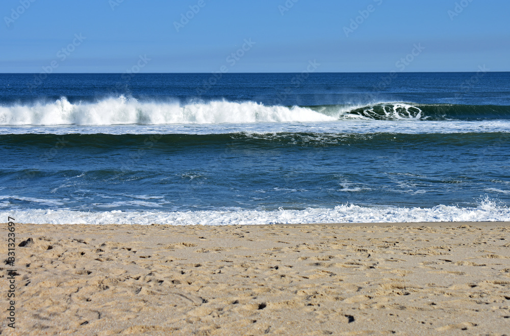 Light winds off the ocean cause waves to crash into the shore at a Sandy Hook, New Jersey, beach -03