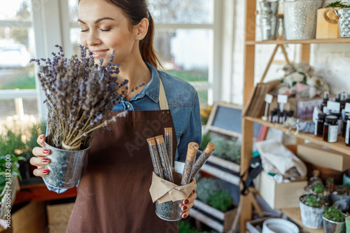 Professional horticulturist enjoying the aroma of wild flowers photo