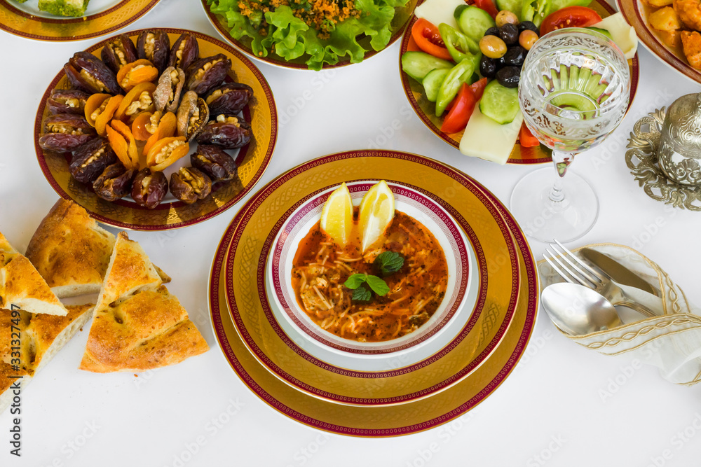 Traditional Ramadan Dinner-Iftar menu designed with elegant dinnerware;soup,dry date fruits,salad,bread and water. Traditional Ramadan Dinner-Iftar menu designed with elegant dinnerware;soup,dry date fruits,salad,bread and water.