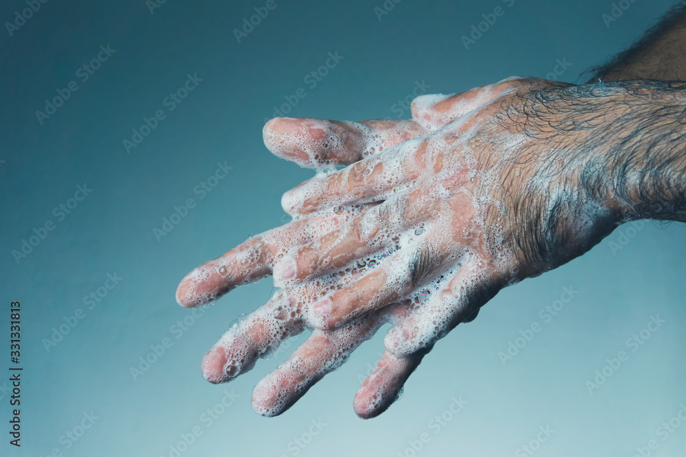 Man washing his hands with soap. Coronavirus transmitted through a hands.